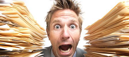 Person panicking with many files around