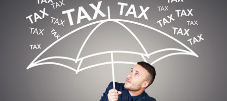 Person under umbrella labeled tax