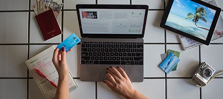 Desk with travel essentials and laptop