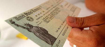 Hands holding government-issued check