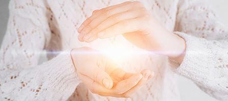 Bright light between gentle hands