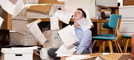 Stressful office environment with scattered documents