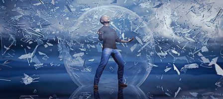 Man shattering glass in cloudy landscape