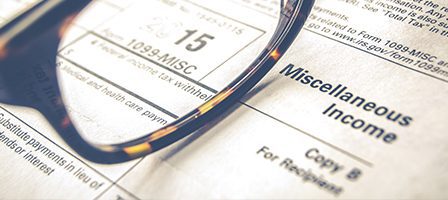 Glasses resting on tax form 1099-MISC