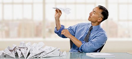 Person playing with paper airplanes