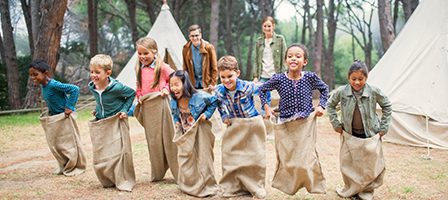 Children enjoying a sack race outdoors