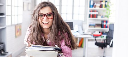 Happy employee holding paperwork