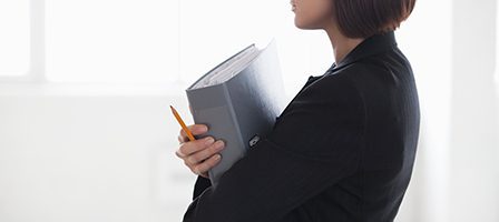 Businesswoman with binder in profile view