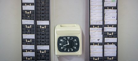 Wall-mounted time clock and card slots