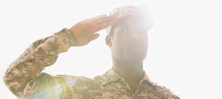 Soldier saluting in bright sunlight