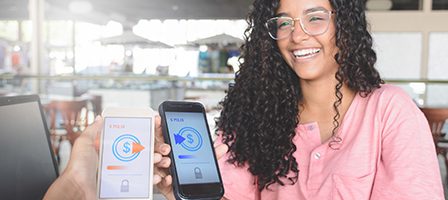 Happy woman using mobile payment app