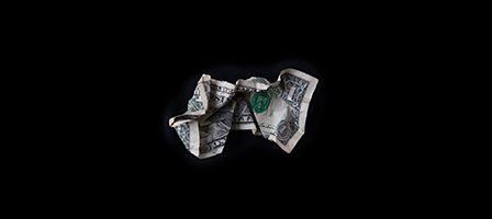 Crumpled dollar bill on black background
