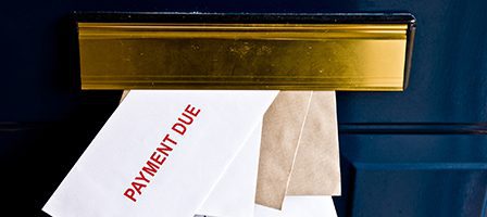 Letters protruding from brass mail slot