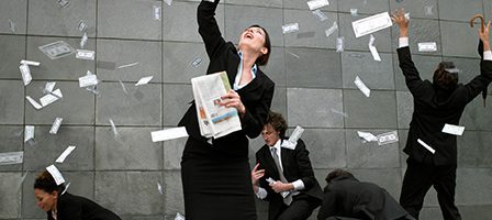 Businesspeople celebrating with falling money