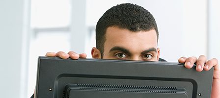Curious individual behind a computer