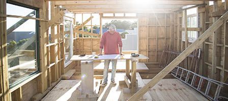 Sunlit room with construction worker