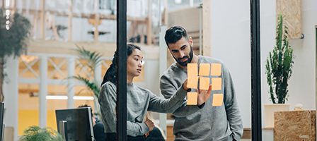 Colleagues brainstorming with sticky notes