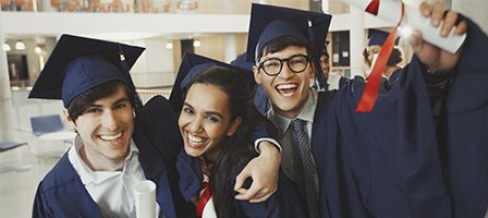 Graduates celebrating in caps and gowns