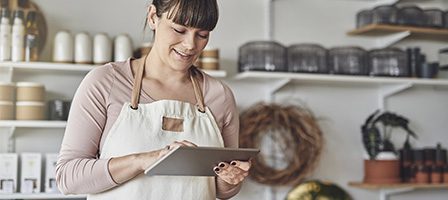Shop owner using tablet in store