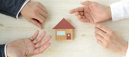 Discussing homeownership with a house model.