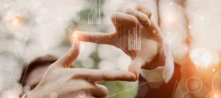 Hands framing digital interface graphics