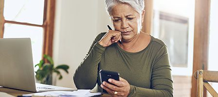 Focused lady looking at mobile device
