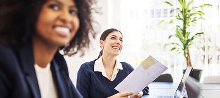 Two women smiling in an office