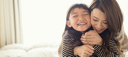 Mother and daughter hugging joyfully