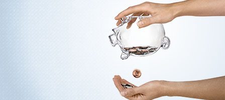 Transparent piggy bank being emptied