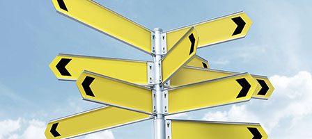 Yellow signpost with black arrow indicators