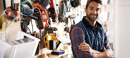 Workshop with various tools and a man