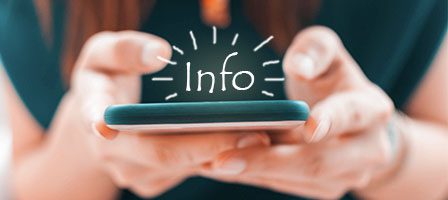 Hands holding smartphone with "Info" text