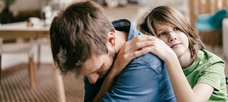 Child comforting adult at home