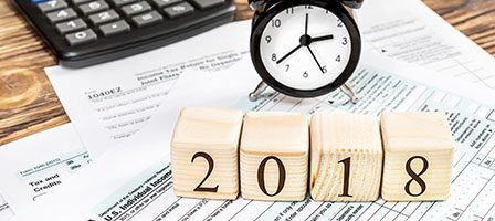 Wooden blocks showing 2018 on tax forms.