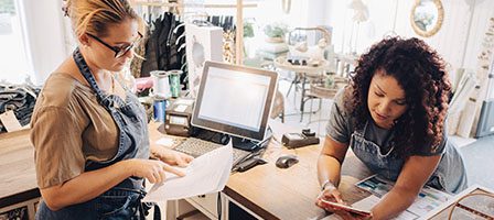 Retail workers discussing shop tasks