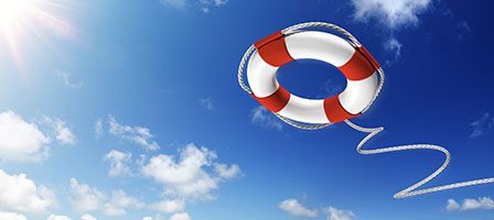 Red and white lifebuoy flying above