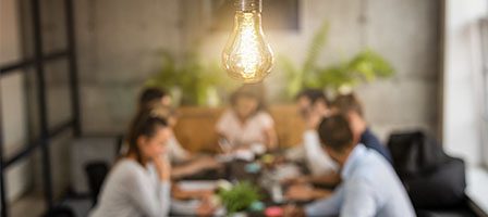 Group discussion under a glowing light