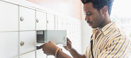 Person retrieving letters from mailbox