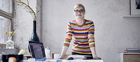 Woman in striped sweater at desk