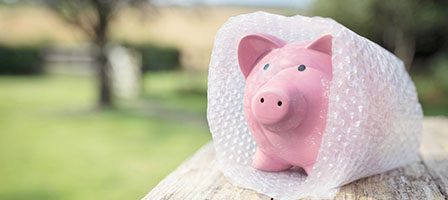 Piggy bank outdoors in bubble wrap
