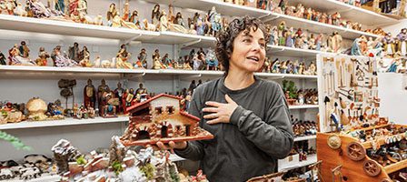 Woman in shop with nativity figurines