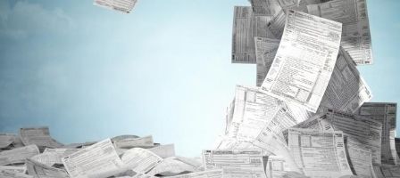 Scattered paperwork against blue sky background