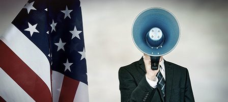 Man in suit, megaphone face, US flag