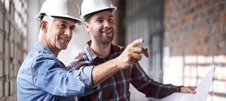 Construction workers discussing building plans