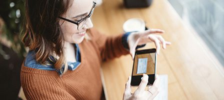 Woman photographing document with smartphone