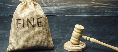 Bag labeled "fine" with gavel nearby