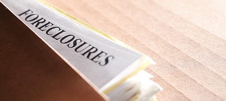 Paper labeled foreclosures on table