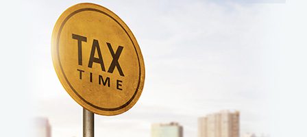 Tax time sign against cityscape