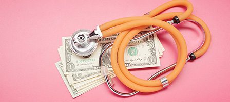 Medical costs concept with stethoscope and cash