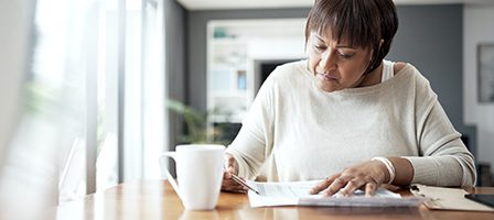 Woman reading documents at a table